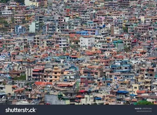 Aerial view of densely developed neighborhoods across Kathmandu Valley, showing extensive urban expansion and limited open space.